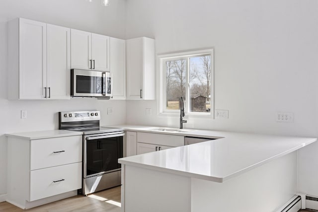 19835 County Road 30, Corcoran, MN 55340 - kitchen featuring stainless steel appliances, a sink, a peninsula, and light countertops