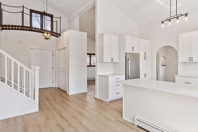 19835 County Road 30, Corcoran, MN 55340 - kitchen with high end refrigerator, high vaulted ceiling, a baseboard radiator, white cabinetry, and light countertops