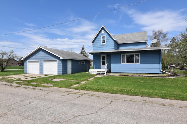 321 1st Ave SW, Baudette, MN 56623 - view of front of property with a detached garage, an outbuilding, and a front lawn
