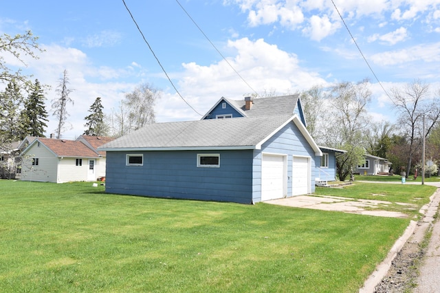 321 1st Ave SW, Baudette, MN 56623 - view of side of home featuring a garage, a yard, roof with shingles, and a chimney