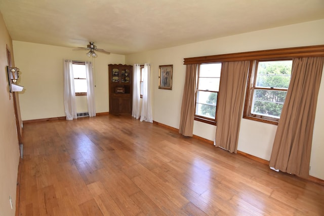 321 1st Ave SW, Baudette, MN 56623 - unfurnished room with light wood finished floors, ceiling fan, and baseboards
