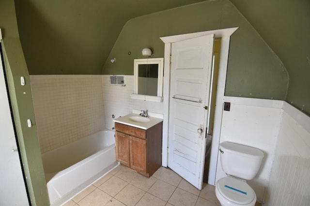 321 1st Ave SW, Baudette, MN 56623 - full bath with tile patterned floors, toilet, vaulted ceiling, a garden tub, and tile walls