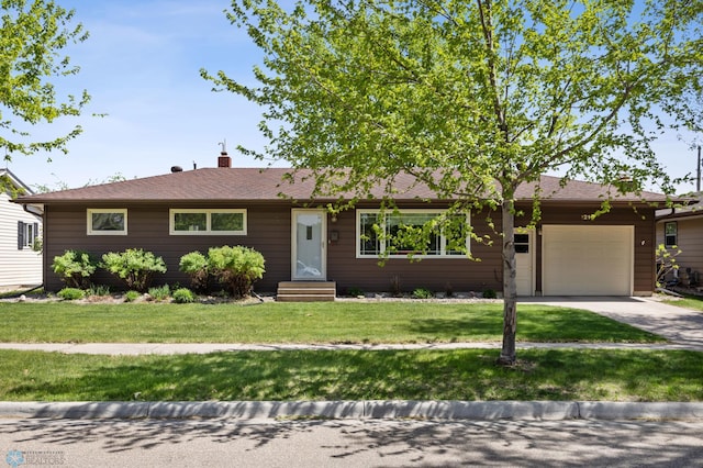 1214 8th St N, Moorhead, MN 56560 - ranch-style house featuring an attached garage, driveway, a front yard, and entry steps
