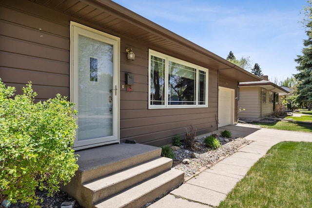 1214 8th St N, Moorhead, MN 56560 - doorway to property with an attached garage and concrete driveway