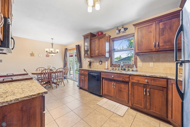 1214 8th St N, Moorhead, MN 56560 - kitchen with black appliances, a chandelier, decorative backsplash, and a sink