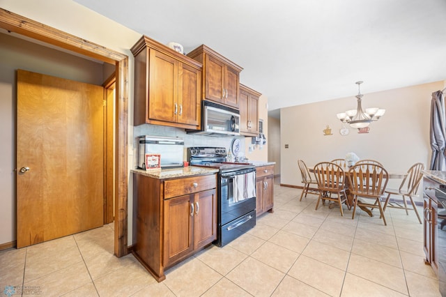 1214 8th St N, Moorhead, MN 56560 - kitchen featuring black / electric stove, stainless steel microwave, a chandelier, and brown cabinetry