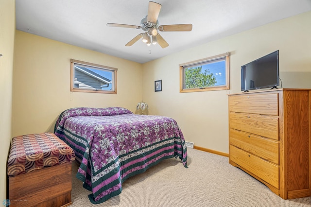 1214 8th St N, Moorhead, MN 56560 - bedroom with carpet, baseboards, and ceiling fan
