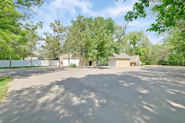7256 Maciver Ave NE, Otsego, MN 55301 - view of property hidden behind natural elements featuring a detached garage, stucco siding, and an outbuilding
