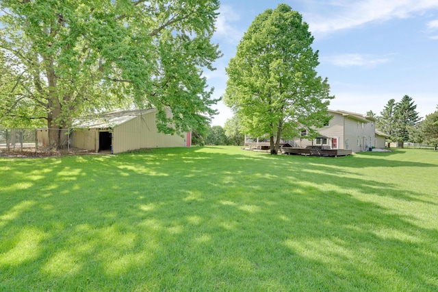 7256 Maciver Ave NE, Otsego, MN 55301 - view of yard featuring a pole building, a wooden deck, and an outbuilding