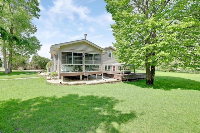 7256 Maciver Ave NE, Otsego, MN 55301 - rear view of property with a wooden deck, a lawn, and a sunroom