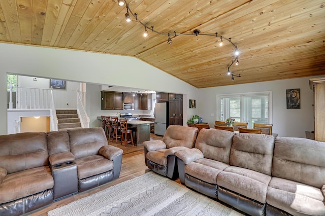 7256 Maciver Ave NE, Otsego, MN 55301 - living area with track lighting, light wood-style floors, vaulted ceiling, wooden ceiling, and stairs
