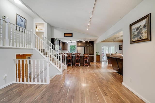 7256 Maciver Ave NE, Otsego, MN 55301 - foyer entrance featuring rail lighting, light wood-style floors, plenty of natural light, and vaulted ceiling