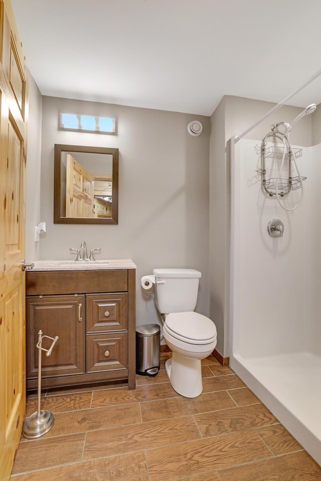 7256 Maciver Ave NE, Otsego, MN 55301 - full bathroom featuring a stall shower, toilet, wood tiled floors, and vanity
