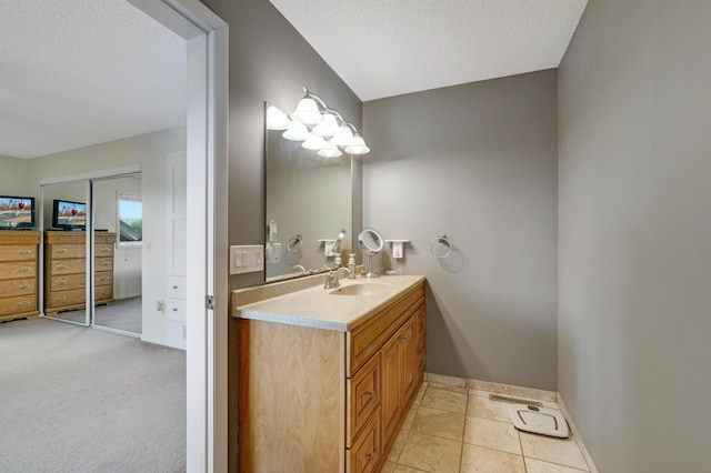 7256 Maciver Ave NE, Otsego, MN 55301 - bathroom featuring baseboards, vanity, and a textured ceiling