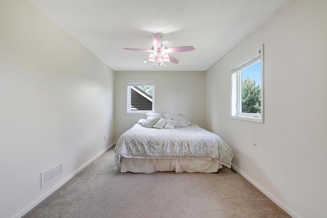 7256 Maciver Ave NE, Otsego, MN 55301 - carpeted bedroom with multiple windows, ceiling fan, a textured ceiling, and baseboards