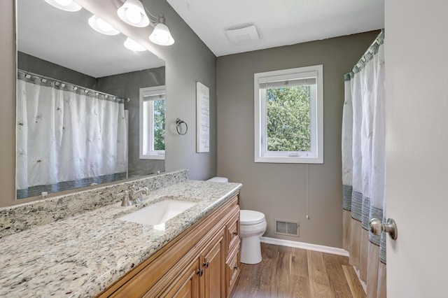 7256 Maciver Ave NE, Otsego, MN 55301 - bathroom with healthy amount of natural light, wood finished floors, baseboards, and toilet