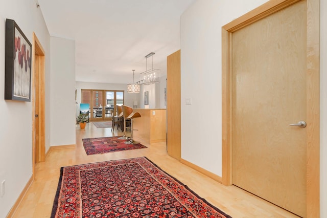 hall featuring wood finished floors and baseboards