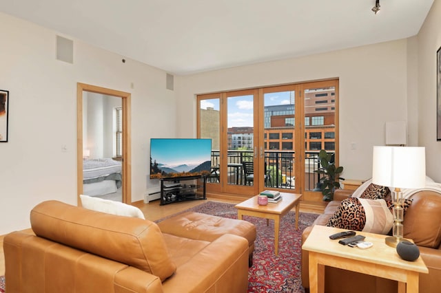 living room with wood finished floors and french doors