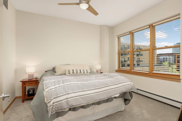 bedroom featuring a baseboard radiator, carpet, baseboards, and ceiling fan