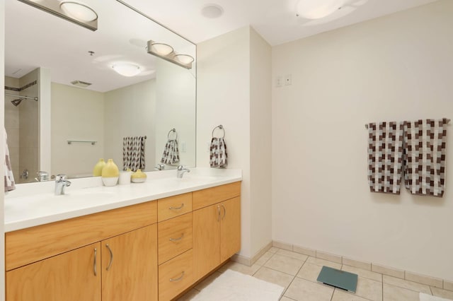 full bath featuring tile patterned flooring, double vanity, and a shower