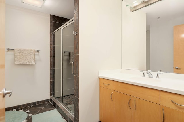 bathroom featuring a shower stall, tile patterned floors, and vanity
