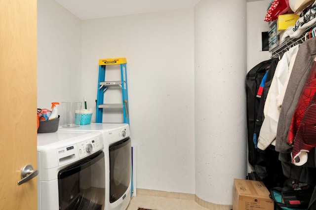 laundry room with washing machine and dryer and light tile patterned flooring