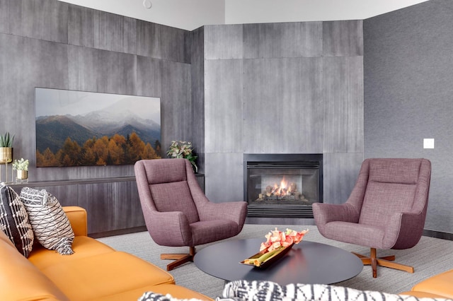 living area featuring a warm lit fireplace