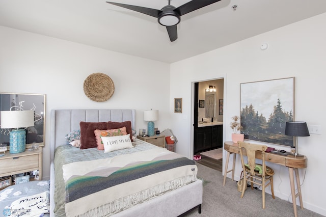 carpeted bedroom with connected bathroom and ceiling fan