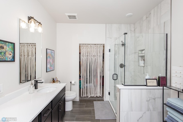 bathroom with toilet, a stall shower, vanity, and wood tiled floors