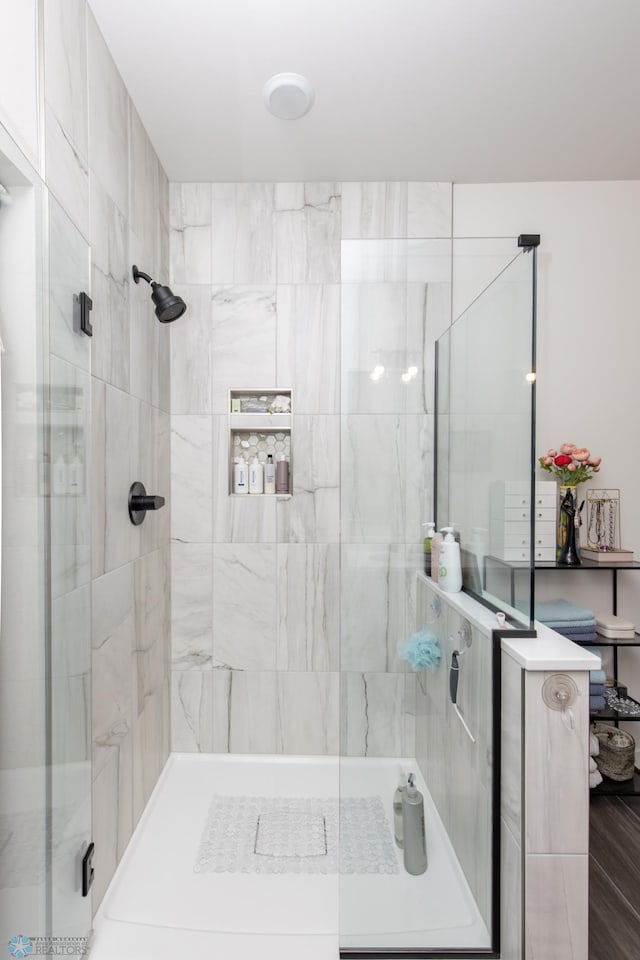 full bath with a tile shower