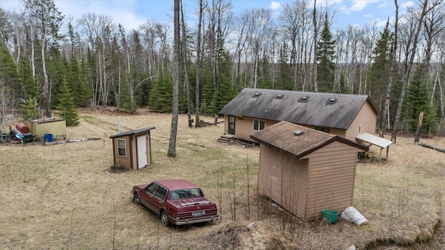 6301 Hunters Pass, Greenwood Twp, MN 55790 - view of home's exterior with roof with shingles and a view of trees