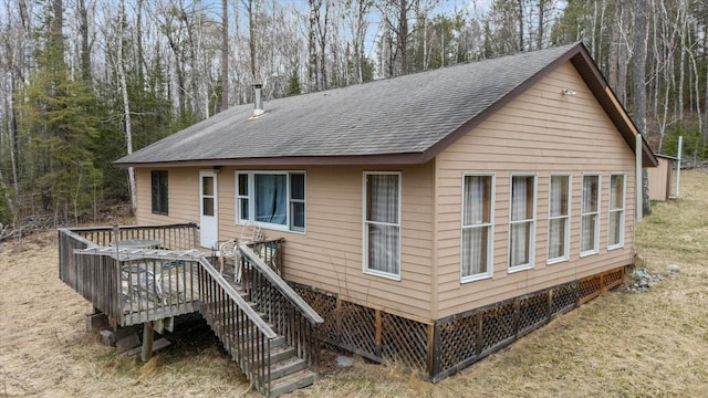 6301 Hunters Pass, Greenwood Twp, MN 55790 - view of home's exterior with a shingled roof and a deck