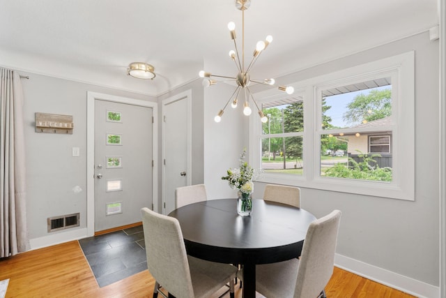 1354 Judith Ave, Roseville, MN 55113 - dining area featuring a chandelier, baseboards, and light wood-style flooring