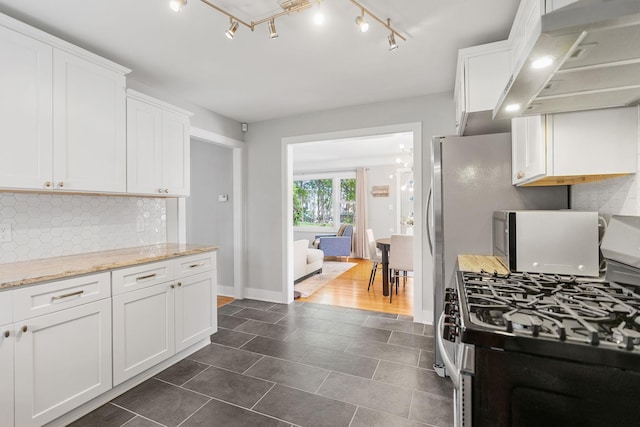 1354 Judith Ave, Roseville, MN 55113 - kitchen featuring stainless steel gas range oven, white cabinetry, decorative backsplash, dark tile patterned flooring, and light stone countertops