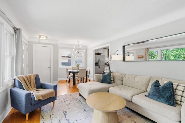 1354 Judith Ave, Roseville, MN 55113 - living room featuring a chandelier, light wood-style flooring, and baseboards