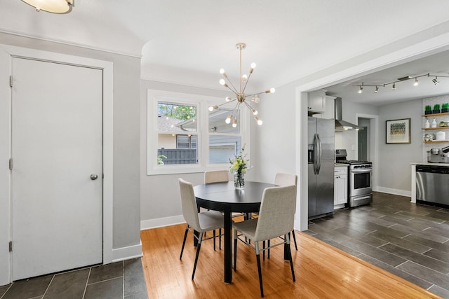 1354 Judith Ave, Roseville, MN 55113 - dining room featuring a chandelier, dark wood-style floors, and baseboards