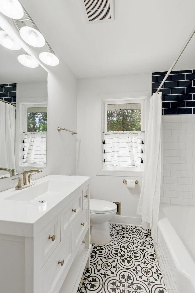 1354 Judith Ave, Roseville, MN 55113 - full bathroom featuring toilet, vanity, shower / bath combo with shower curtain, and tile patterned flooring