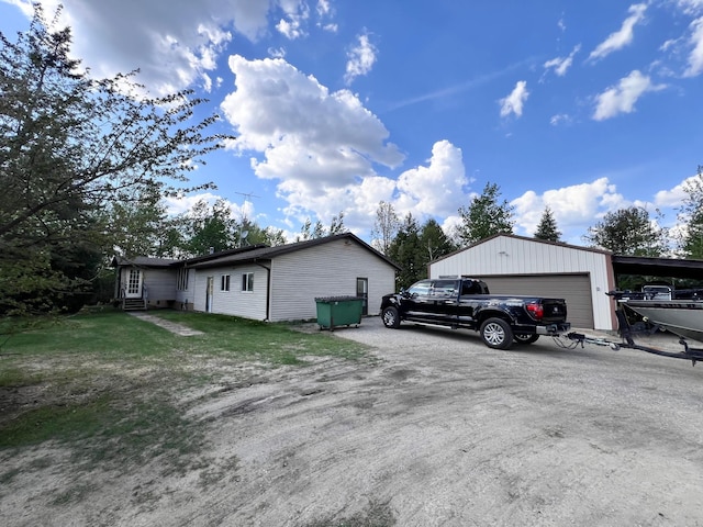 3186 State Highway 11 SE, Baudette, MN 56623 - view of side of home with a garage, an outbuilding, and entry steps