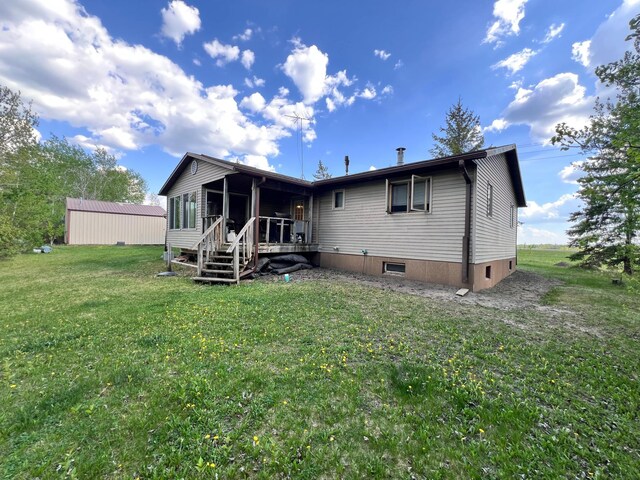 3186 State Highway 11 SE, Baudette, MN 56623 - rear view of property with a yard and a sunroom
