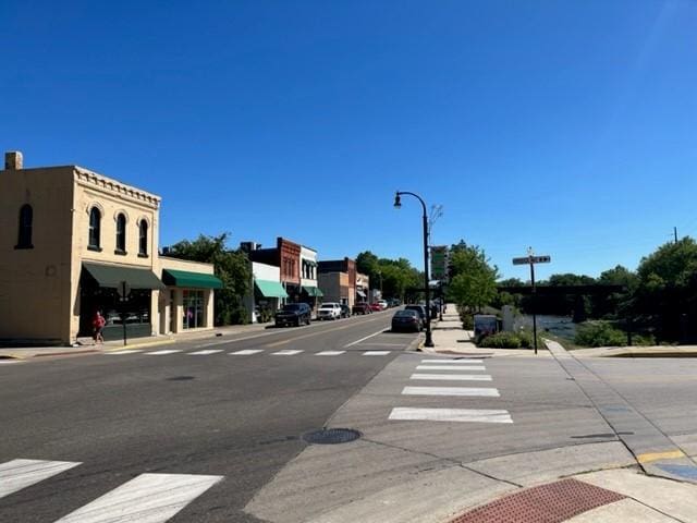930 Silvercreek Ave W, Delano, MN 55328 - view of asphalt street with sidewalks, street lights, and curbs