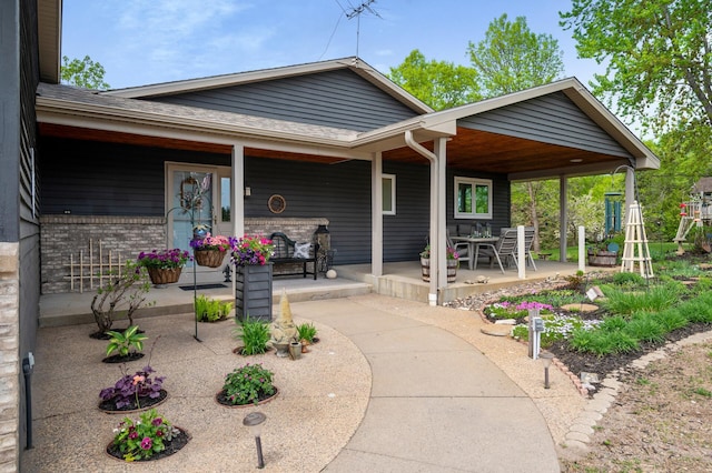 15777 Grover Ave NW, Clearwater Twp, MN 55320 - view of front of home featuring a porch, roof with shingles, and brick siding