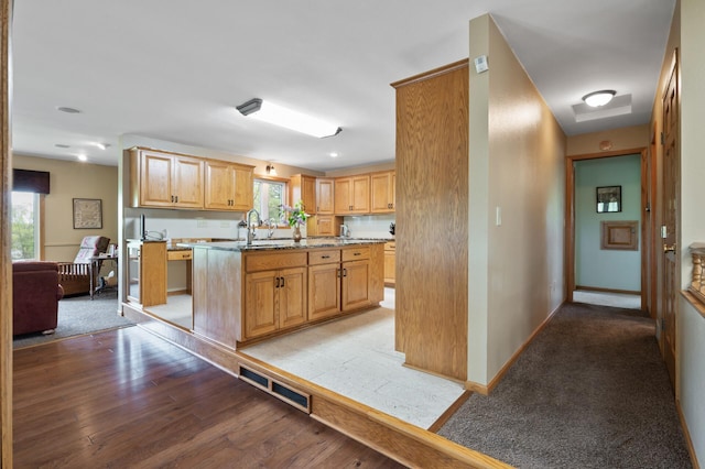 15777 Grover Ave NW, Clearwater Twp, MN 55320 - kitchen with plenty of natural light, a sink, a kitchen island with sink, and light wood finished floors