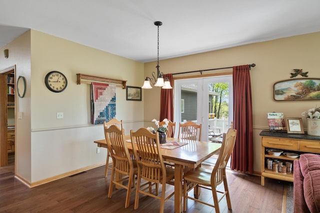15777 Grover Ave NW, Clearwater Twp, MN 55320 - dining space featuring a chandelier, wood finished floors, and baseboards