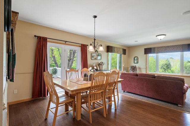 15777 Grover Ave NW, Clearwater Twp, MN 55320 - dining space featuring dark wood finished floors, a chandelier, and baseboards