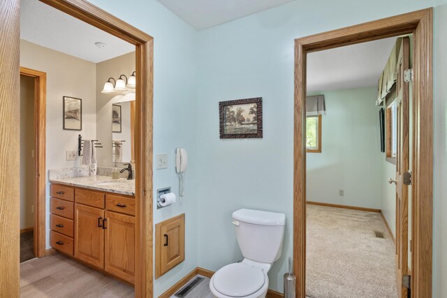 15777 Grover Ave NW, Clearwater Twp, MN 55320 - bathroom with toilet, vanity, and baseboards