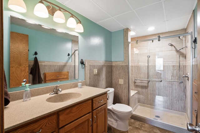 15777 Grover Ave NW, Clearwater Twp, MN 55320 - bathroom with a stall shower, toilet, vanity, tile walls, and wainscoting