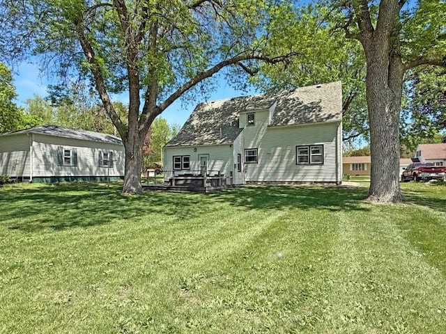 213 1st Ave E, Truman, MN 56088 - rear view of property featuring a yard and a wooden deck