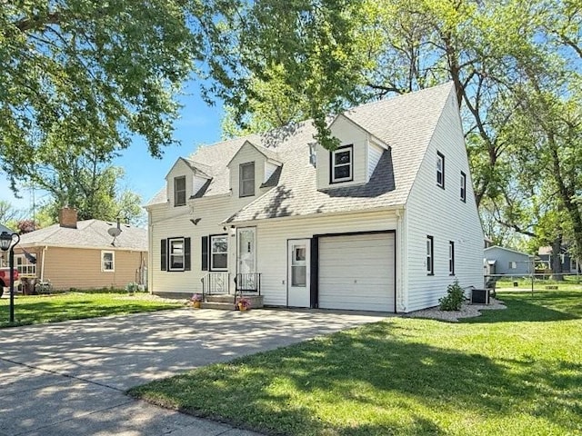 213 1st Ave E, Truman, MN 56088 - cape cod-style house with driveway, a front yard, central AC, and a shingled roof