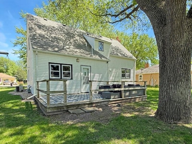 213 1st Ave E, Truman, MN 56088 - rear view of house featuring a yard, a deck, central AC unit, and roof with shingles