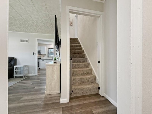213 1st Ave E, Truman, MN 56088 - staircase featuring wood finished floors, baseboards, and ornamental molding